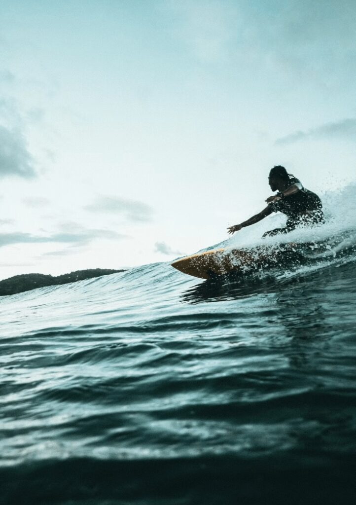 A surfer rides a wave in Lombok, Indonesia