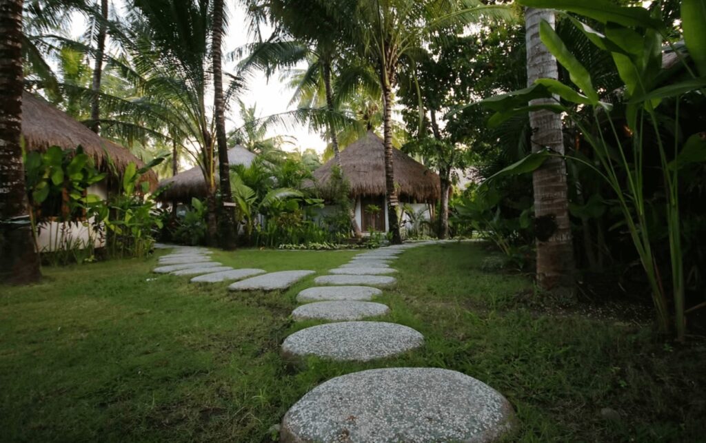 Stepping stones lead through an eco-friendly resort in Lombok - one of the best places to surf in Indonesia