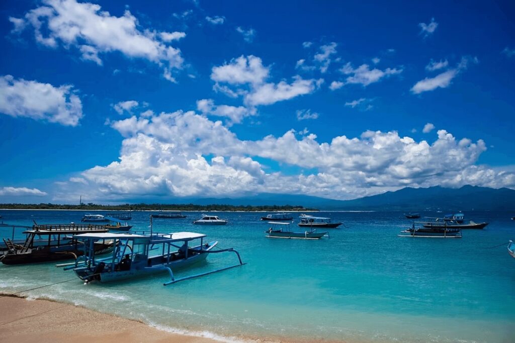Fishing boats moored in turquoise waters along the coast of Lombok, Indonesia