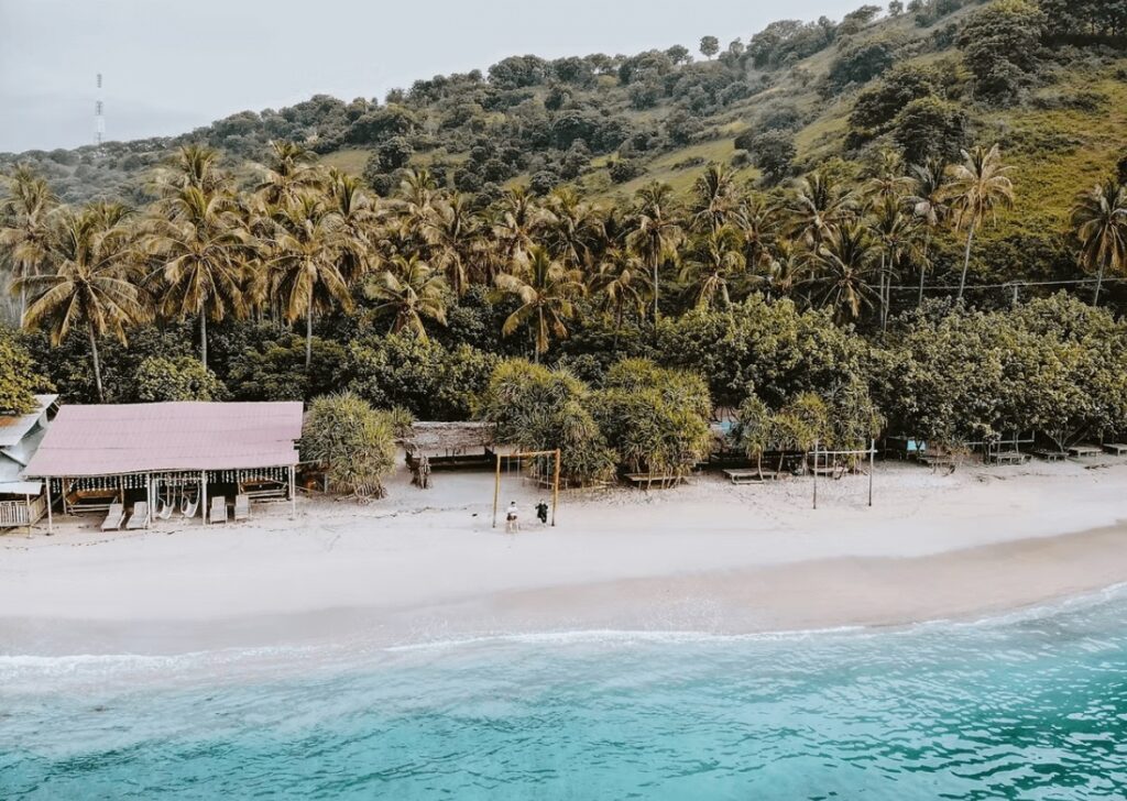 An elevated view of a beach in Lombok - one of the best places to learn to surf in Indonesia