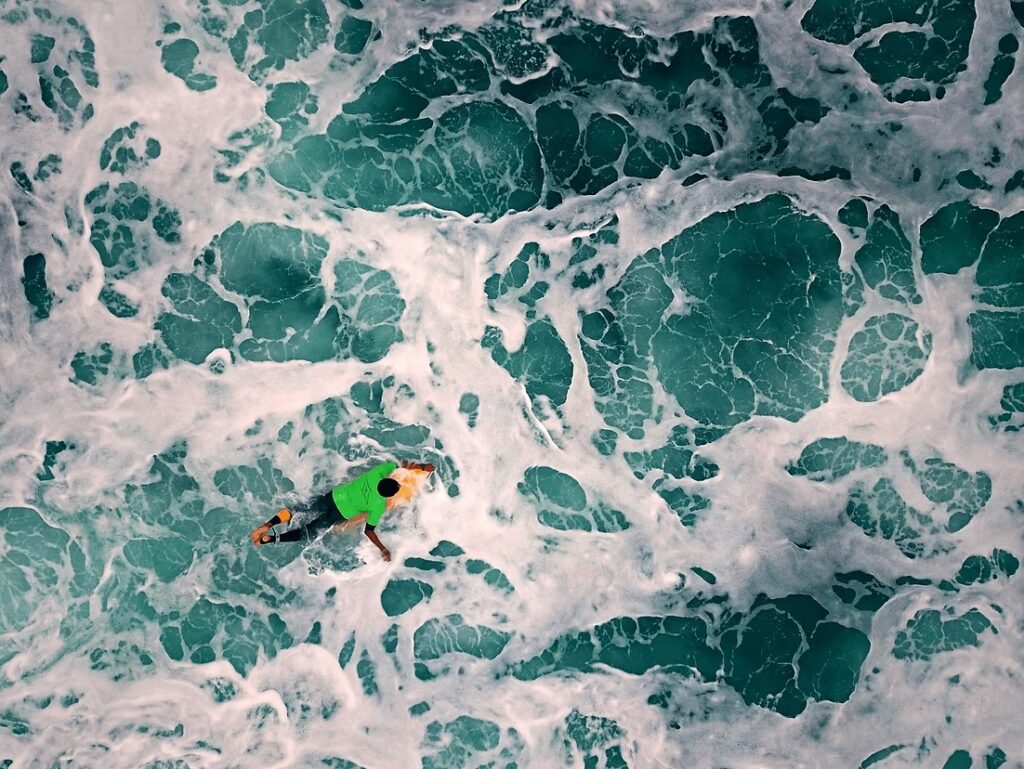 Sustainable surf trip to Tonga: An aerial view of a surfer in Tonga