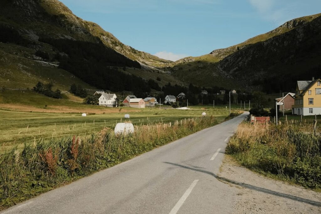 A road leads between traditional houses in Hoddevik, one of the best places to surf in Norway