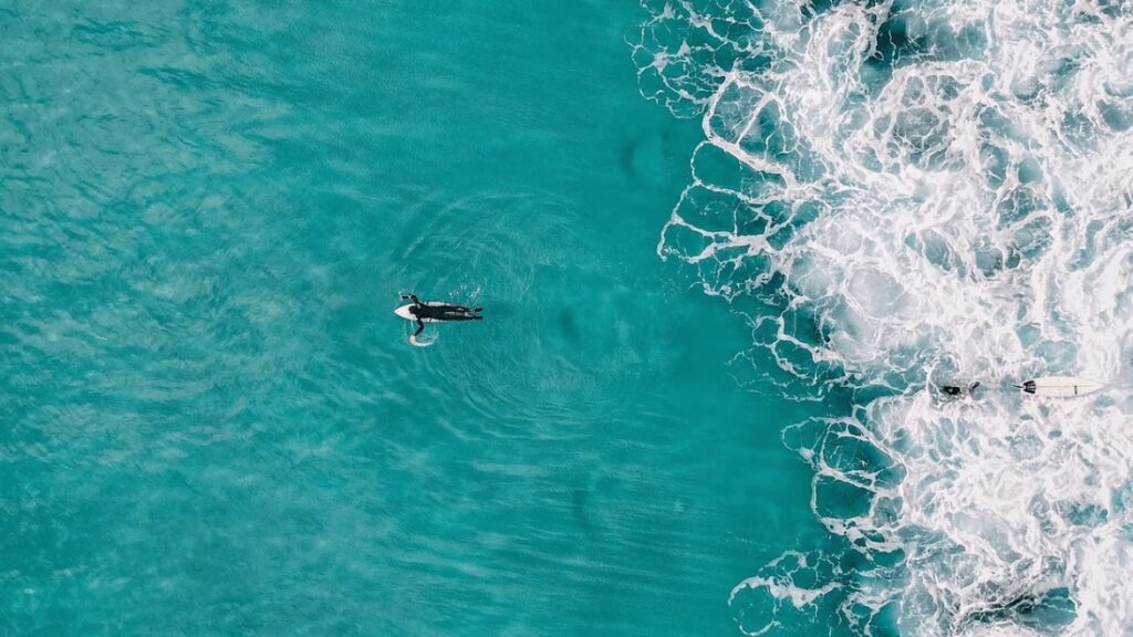 Surfing in Pohnpei: An aerial view of a surfer paddling beyond a break