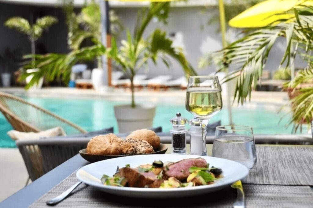 Dining poolside at the Boma Lifestyle Hotel, one of the best eco-friendly hotels in Dakar 