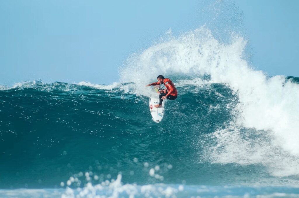 Sustainable surf organisations to follow: A pro surfer rides a wave in South Africa