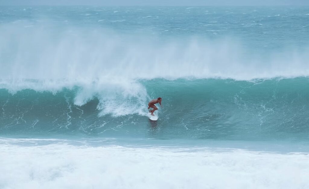 Sustainable surf trip to Sri Lanka: A surfer rides a wave in Sri Lanka