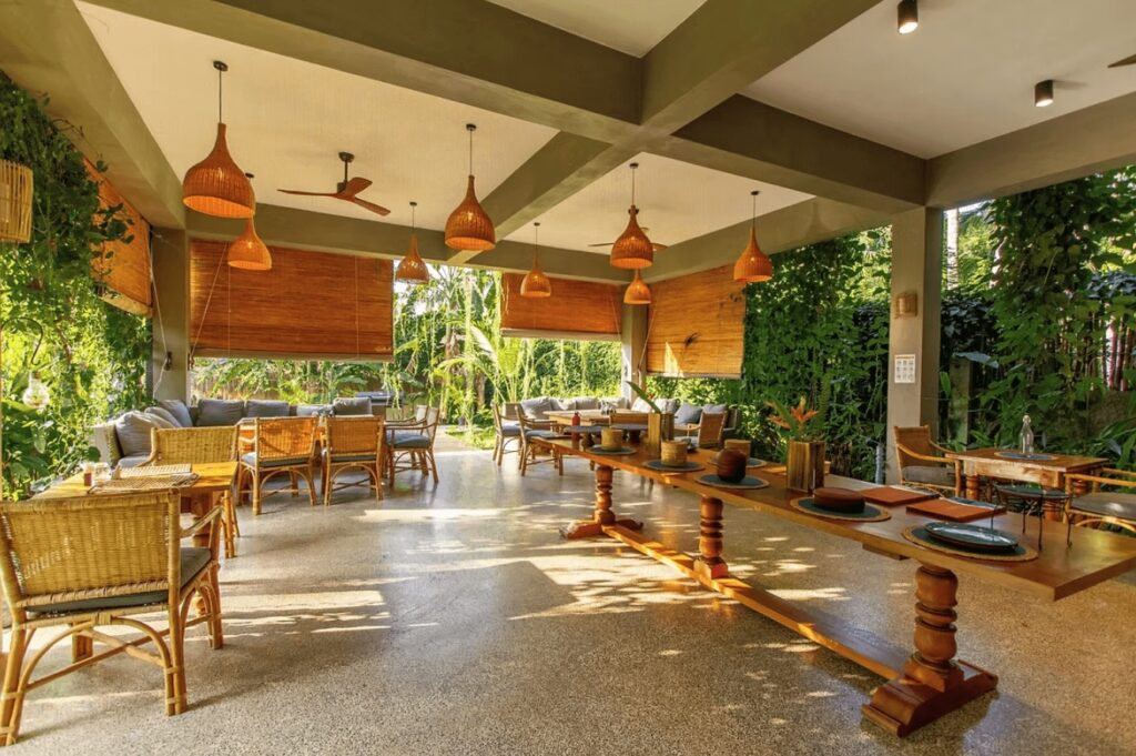 The communal dining space at The Jungalows, an eco-friendly surf camp in Hiriketiya 