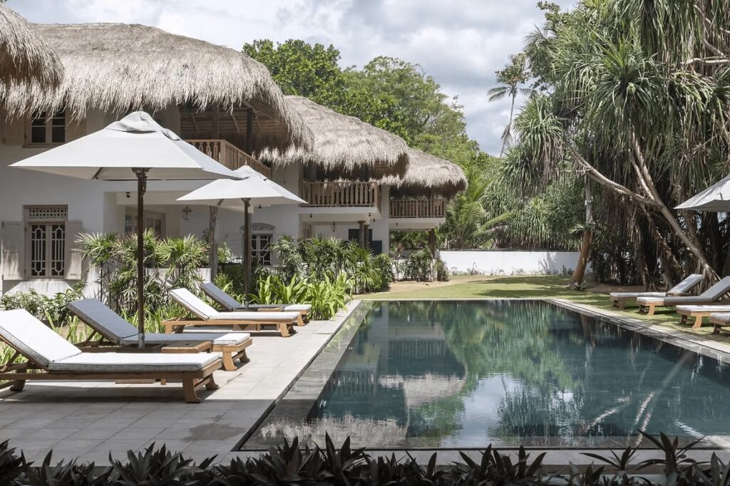 An outdoor pool fringed by sun loungers at Halcyon Mawella, an eco-friendly hotel in Sri Lanka 