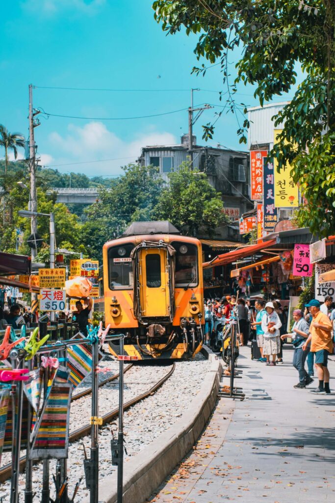 Surfing in Taiwan: A yellow train rolls through a busy market
