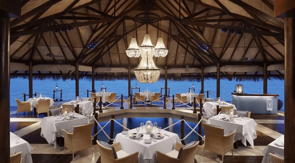 An opulent overwater dining space at Taj Exotica Resort & Spa in the Maldives