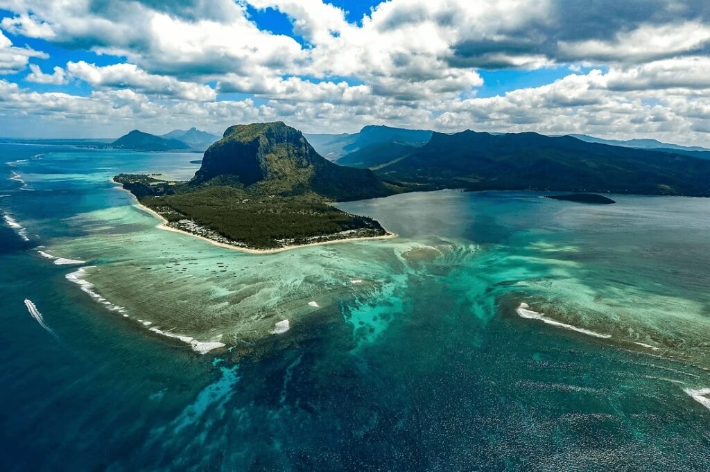 A coral reef fringes an island in the South Pacific
