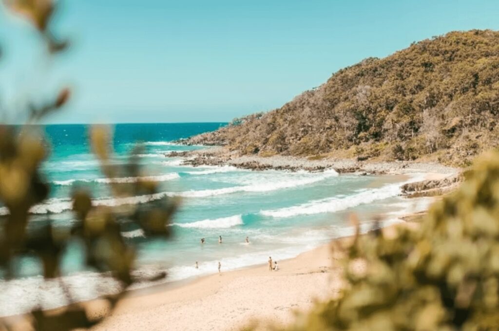 Waves roll into a beach in Noosa - one of the World Surfing Reserves