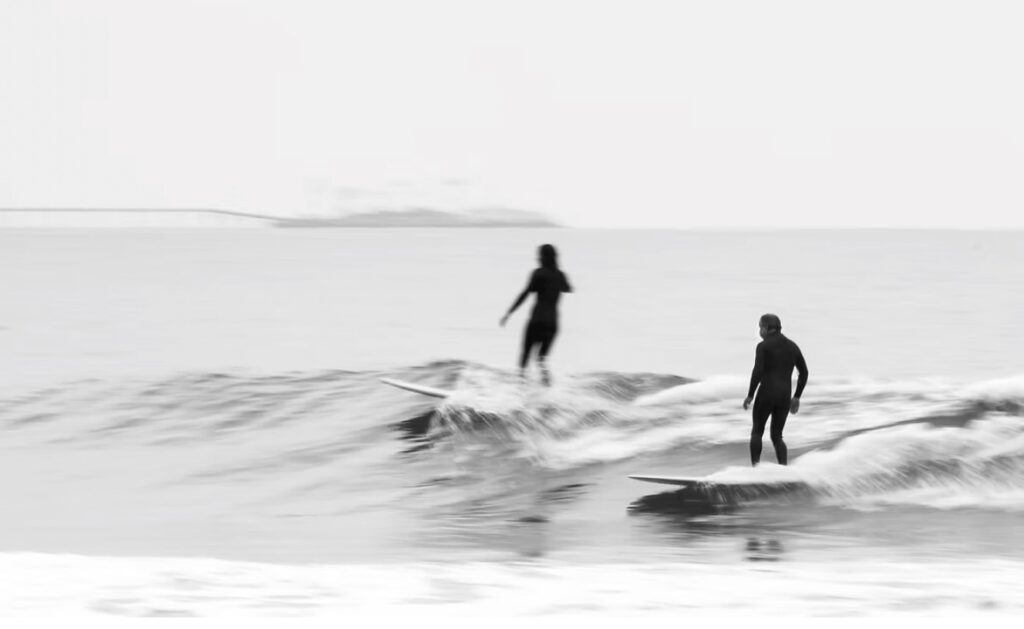 STOKE certification: Two surfers share a "party wave"