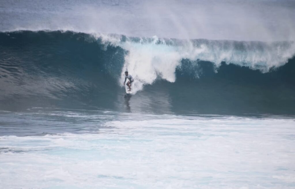A surfer rides "Cloud 9" - a legendary surf spot in Siargao