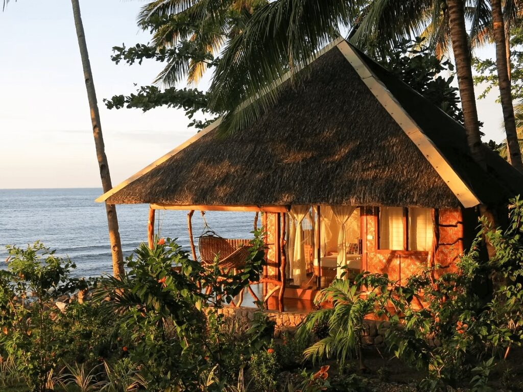 One of the thatched roof bungalows at Camiguin Volcan Beach Eco Retreat in the Philippines