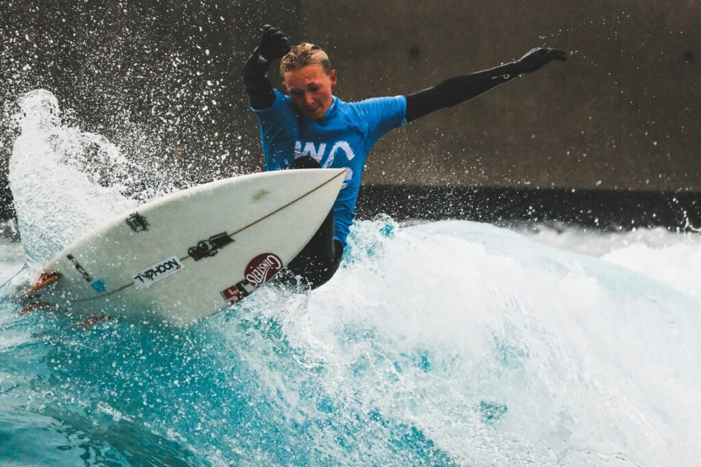 A surfer rides an artifical wave at a surf park in the UK