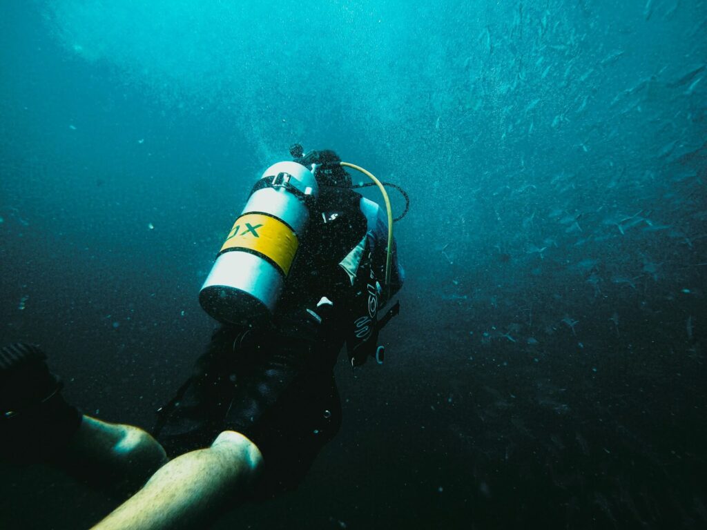 A scuba diver with a tank of NItrox