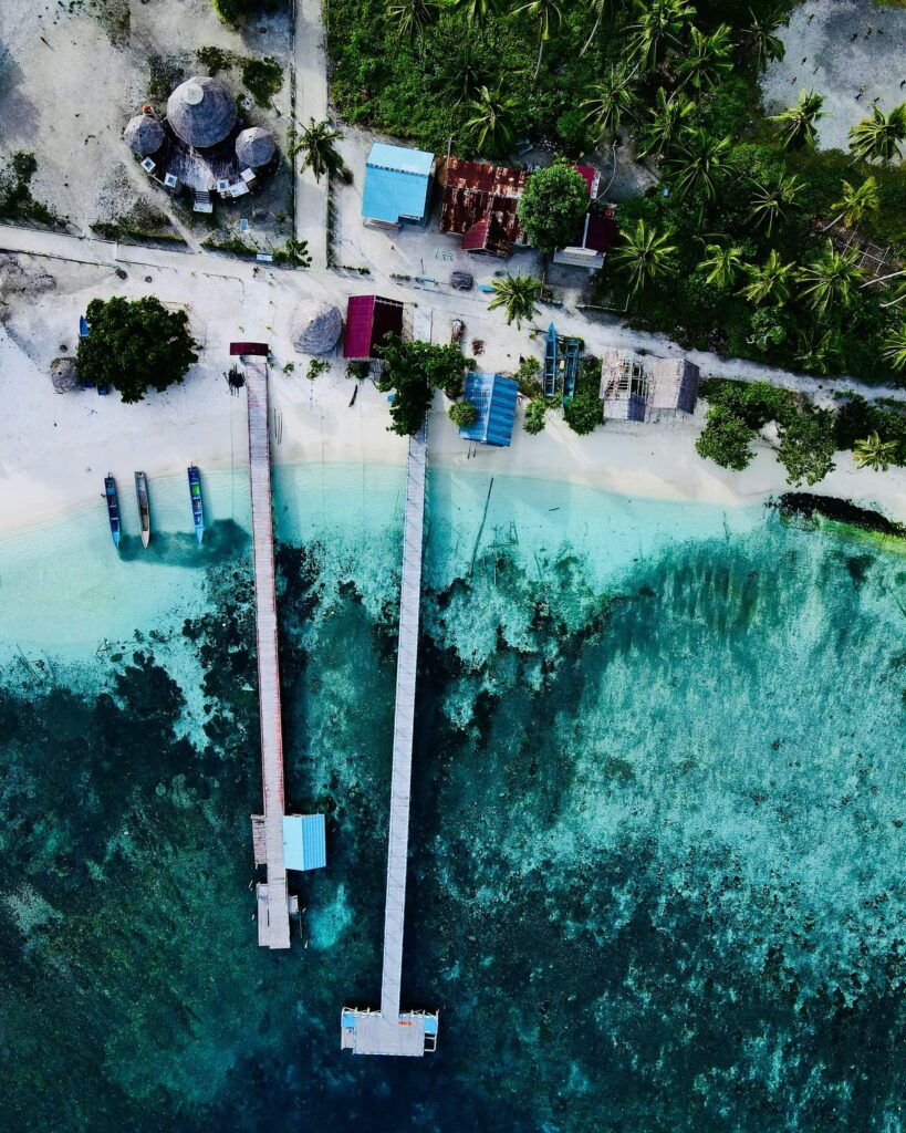 An elevated view of a Raja Ampat homestay and jetty
