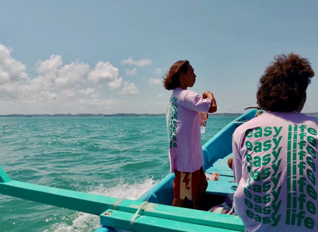 Riding the boat out to Ekas with the EasyLife team